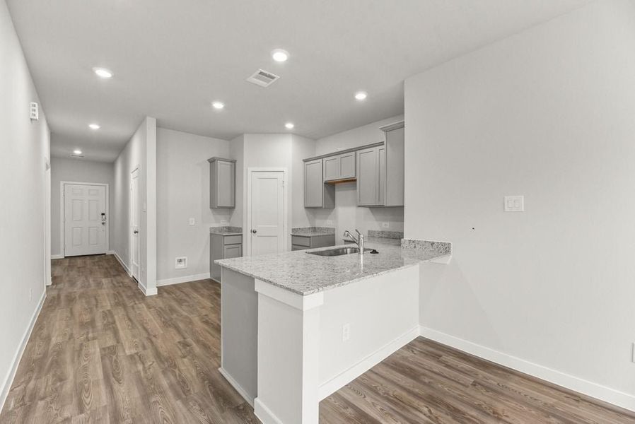 A kitchen with white cabinets.
