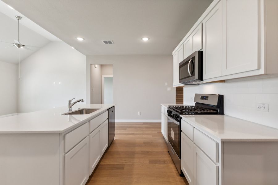 Kitchen in the Masters home plan by Trophy Signature Homes – REPRESENTATIVE PHOTO