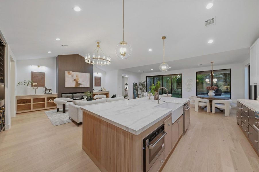 Thoughtful electrical details throughout the kitchen include concealed outlet strips, under-cabinet lighting, and hidden charging stations designed for modern everyday living.