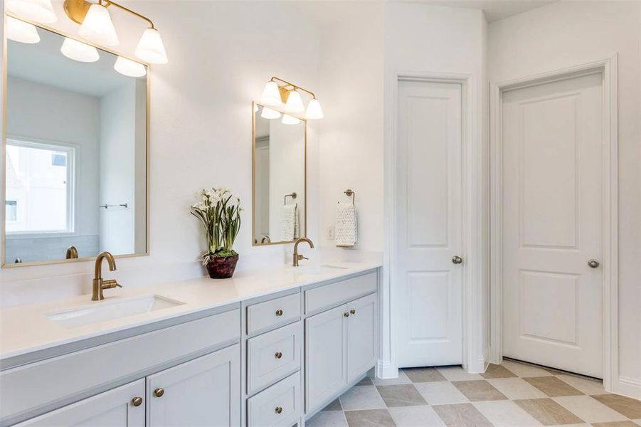 Full bath featuring double vanity and light flooring Full bath featuring double vanity and light flooring
