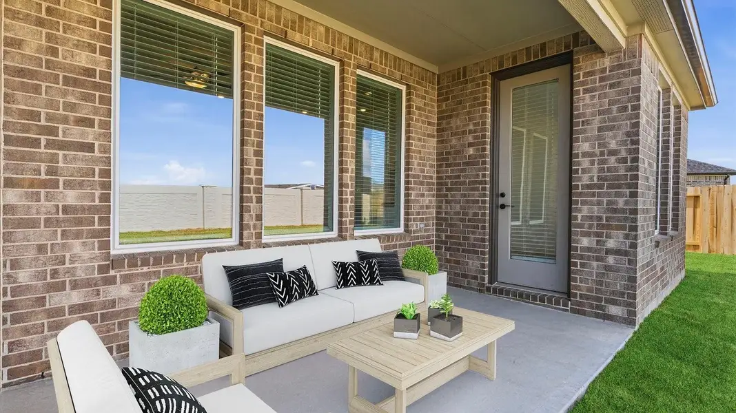 Outdoor covered patio with seating area overlooking a well-maintained lawn, perfect for relaxation. Outdoor covered patio with seating area overlooking a well-maintained lawn, perfect for relaxation.