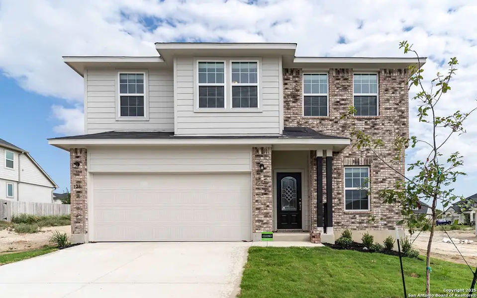 Front exterior of a new home in Hunter's Ranch, San Antonio, TX, highlighting curb appeal (Image 1). Front exterior of a new home in Hunter's Ranch, San Antonio, TX, highlighting curb appeal (Image 1).