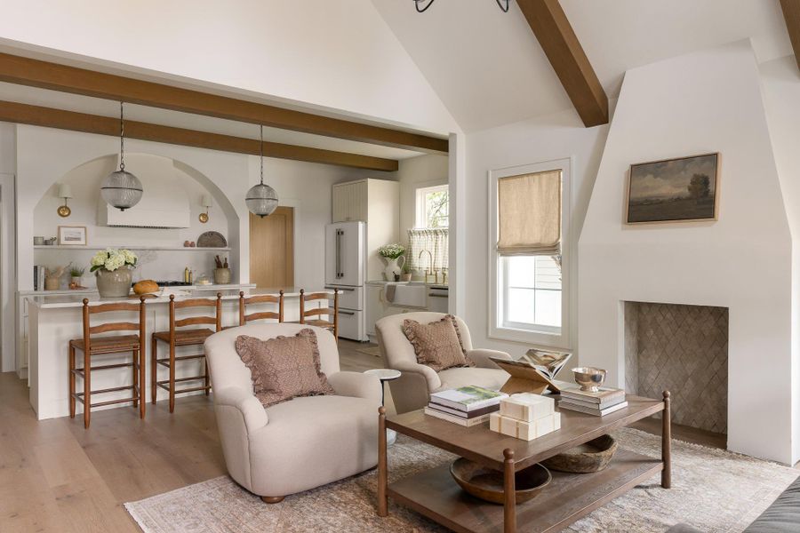 Living room opens up to kitchen, Vaulted ceiling with exposed faux wood beams, and upgraded high-end engineered white oak hardwood flooring throughout the house Living room opens up to kitchen, Vaulted ceiling with exposed faux wood beams, and upgraded high-end engineered white oak hardwood flooring throughout the house