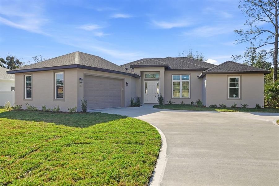 Front exterior of a new home in , Palm Coast, FL, highlighting curb appeal (Image 21).