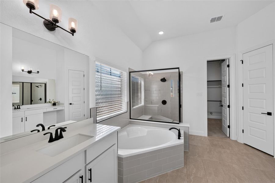 A spacious bathroom features tile flooring, a corner soaking tub, and a separate glass shower. A spacious bathroom features tile flooring, a corner soaking tub, and a separate glass shower.