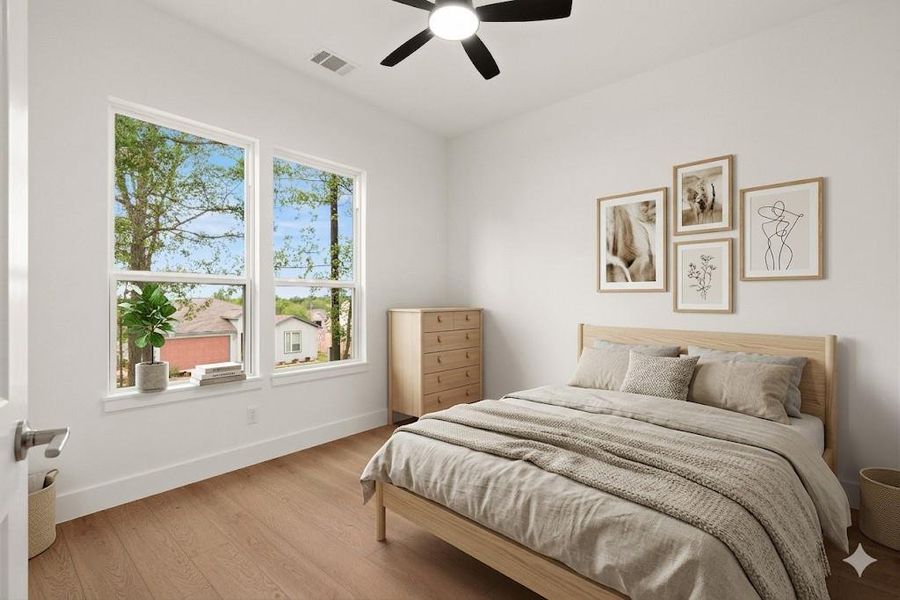First Bedroom at the front of the house, featuring micro beveled lvp  floors and ceiling fan