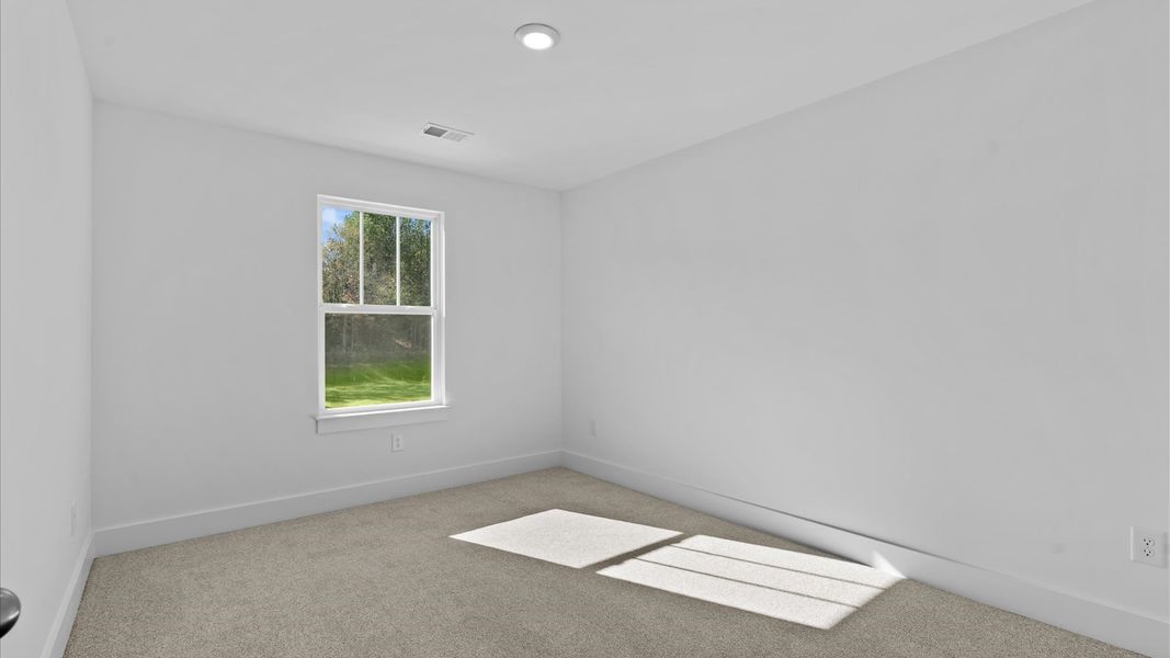 Notable bedroom offering soft carpet, a walk-in closet, and expansive windows