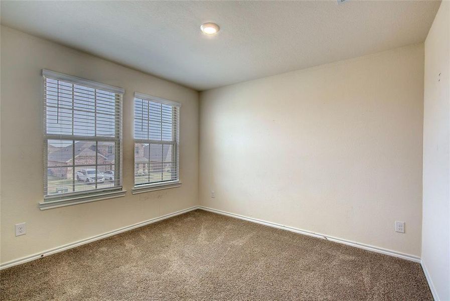 Carpeted spare room with baseboards