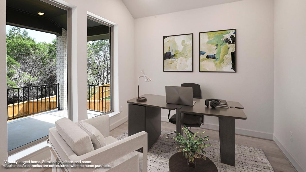 Home office with light wood finished floors and lofted ceiling