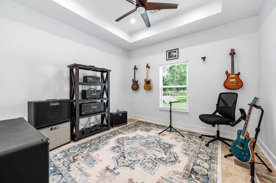 This versatile secondary bedroom is currently set up as a creative music space, featuring abundant natural light and plenty of room for a variety of uses. Whether used as a bedroom, office, hobby room, or studio, the space offers flexibility to fit your lifestyle.