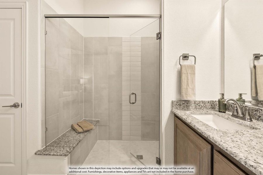 Bathroom with glass walk-in shower, built-in bench, and granite vanity countertop with undermount sink