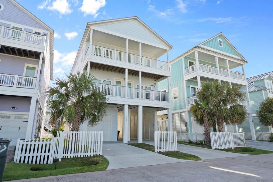 Clean lines and coastal charm. From the solid concrete drive to the swaying Sabal Palm, this sunny side view shows off the home’s polished foundation and island-inspired personality—easygoing, low-maintenance, and ready for beach life. Clean lines and coastal charm. From the solid concrete drive to the swaying Sabal Palm, this sunny side view shows off the home’s polished foundation and island-inspired personality—easygoing, low-maintenance, and ready for beach life.