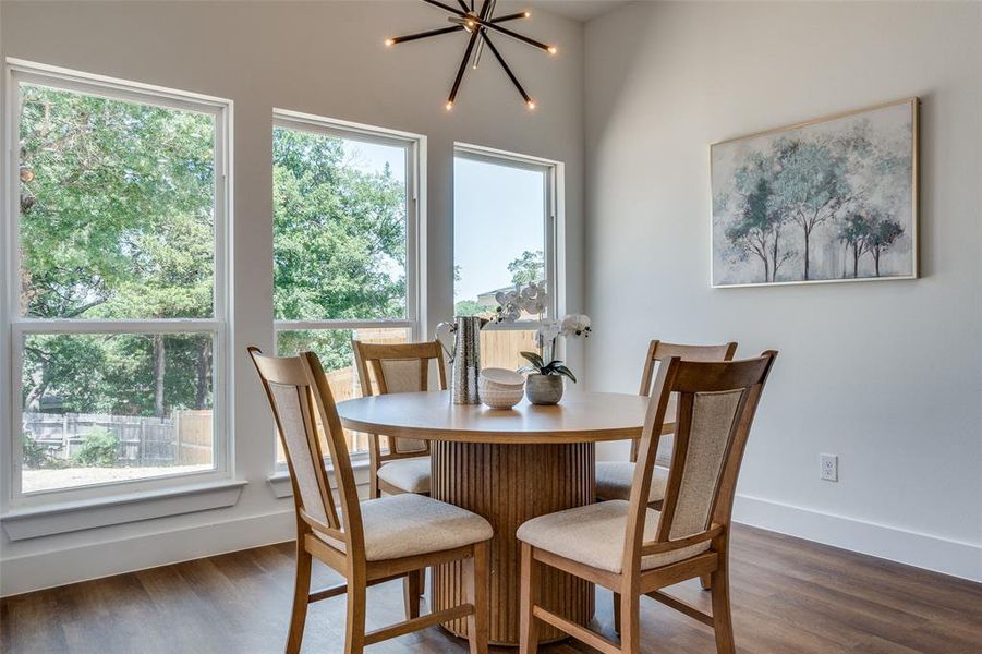 Dining space with a notable chandelier and dark hardwood / wood-style floors