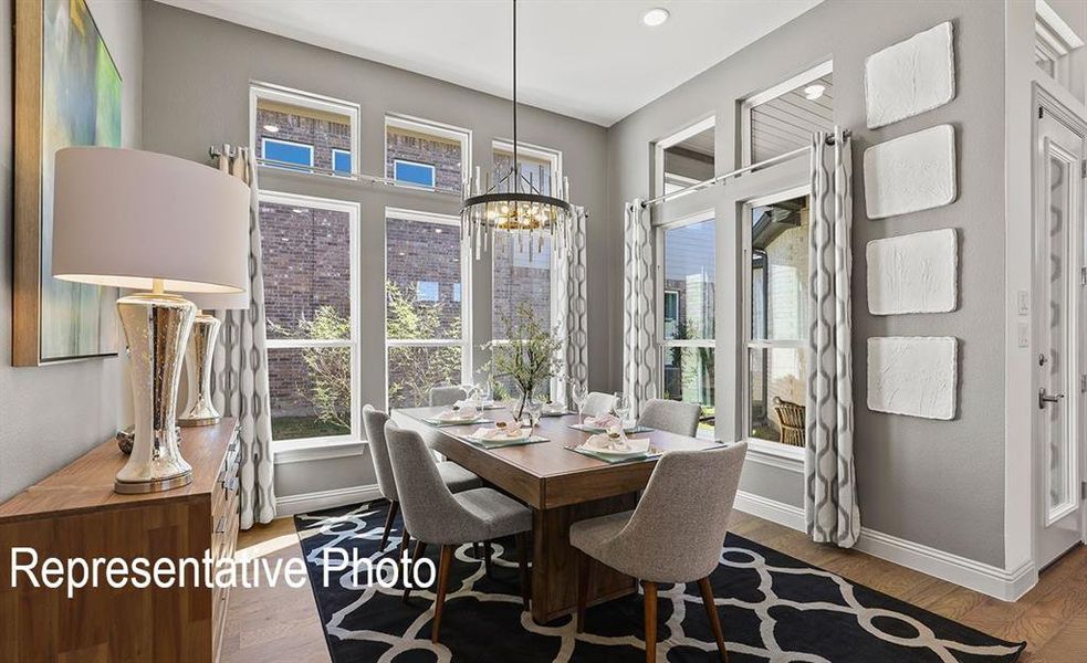 Dining area with an inviting chandelier and hardwood / wood-style floors