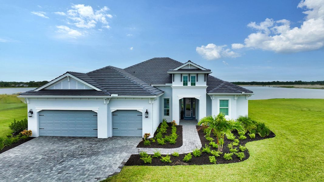 Front exterior of a new home in SkySail Real Estate and Homes for Sale in Naples, FL - Neal Communities, Naples, FL, highlighting curb appeal (Image 2). Front exterior of a new home in SkySail Real Estate and Homes for Sale in Naples, FL - Neal Communities, Naples, FL, highlighting curb appeal (Image 2).