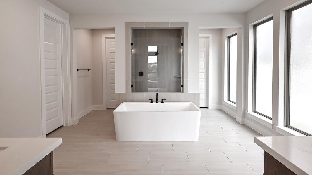 Full bathroom with a soaking tub, vanity, and a walk in shower Full bathroom with a soaking tub, vanity, and a walk in shower