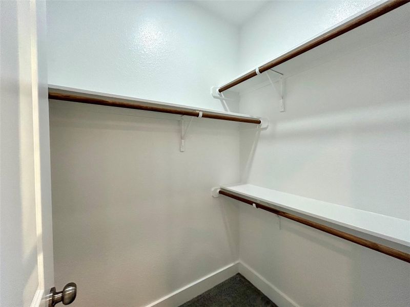 Walk-in closet in one of the small bedrooms.