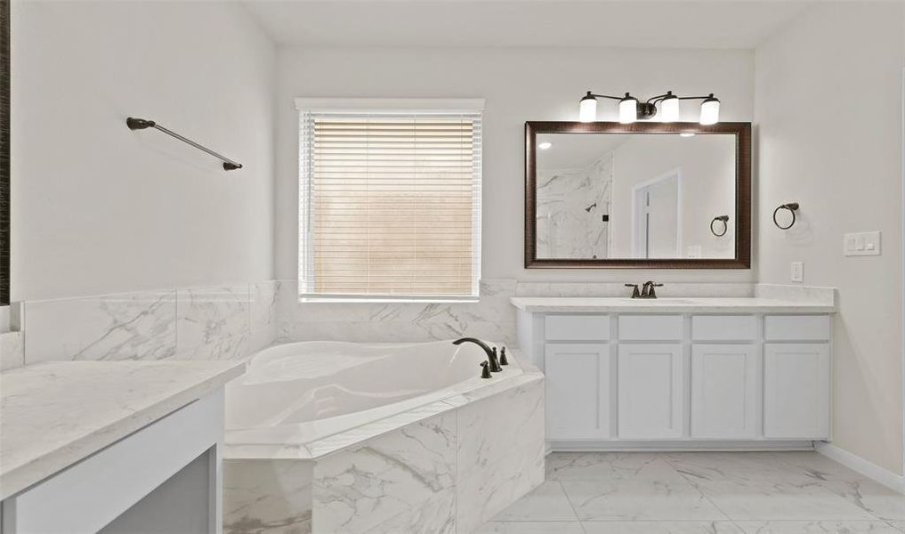 Luxurious owner's bath with dual vanities and soaking tub (*Photo not of actual home and used for illustration purposes only.)