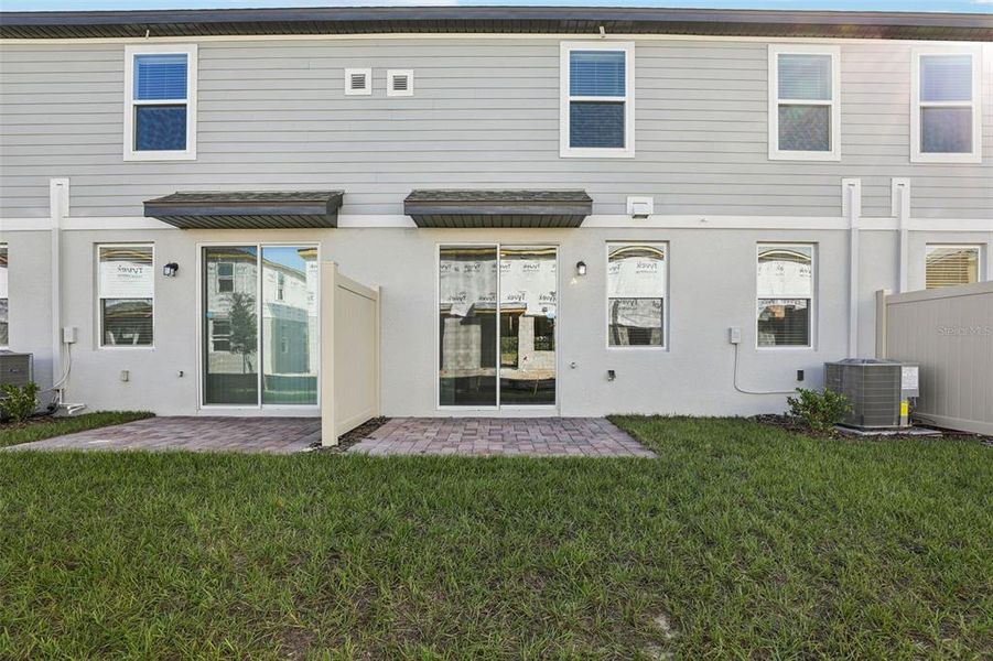 Exterior details and patio area of a home in The Meadow at Crossprairie Bungalows, St. Cloud (Image 4).