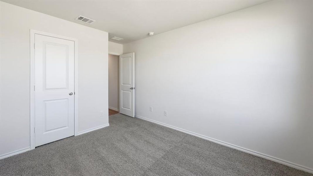 Unfurnished bedroom featuring carpet flooring and baseboards Unfurnished bedroom featuring carpet flooring and baseboards