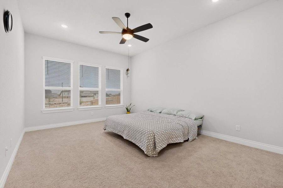 Bedroom featuring carpet floors, a ceiling fan, and recessed lighting
