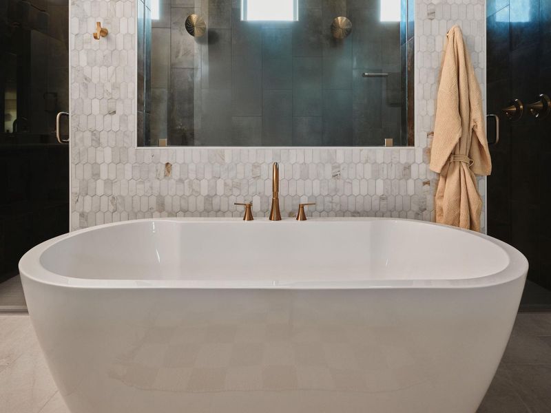 The ensuite features a timeless free-standing soaking tub for ultimate relaxation.