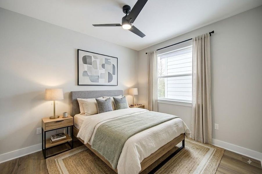 Large third floor bedroom with ceiling fan.