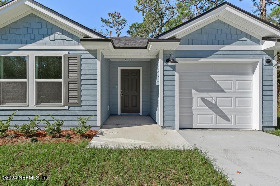 Front exterior of a new home in , Satsuma, FL, highlighting curb appeal (Image 1).