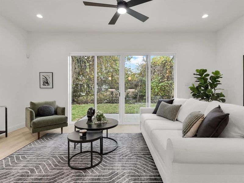 Living room featuring hardwood / wood-style floors and ceiling fan