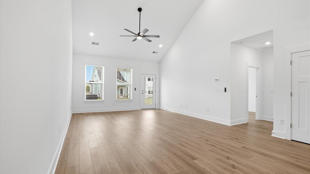 Spacious and stylish family room with two-story ceilings that create a bright and open atmosphere at Village at Midway Spacious and stylish family room with two-story ceilings that create a bright and open atmosphere at Village at Midway
