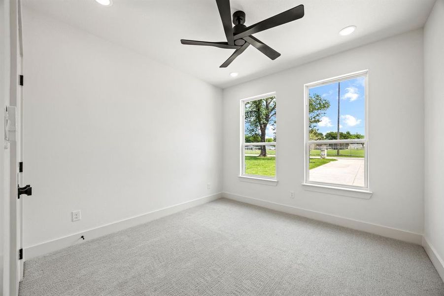 Spare room with baseboards, light carpet, recessed lighting, and a ceiling fan Spare room with baseboards, light carpet, recessed lighting, and a ceiling fan