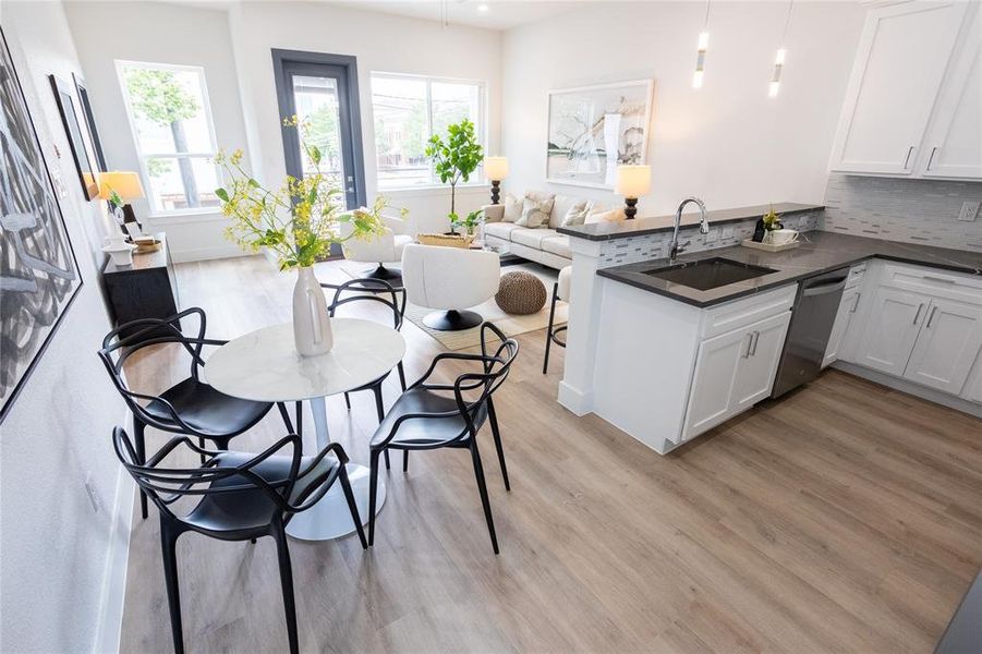 Kitchen featuring kitchen peninsula, white cabinets, sink, light hardwood / wood-style flooring, and dishwasher