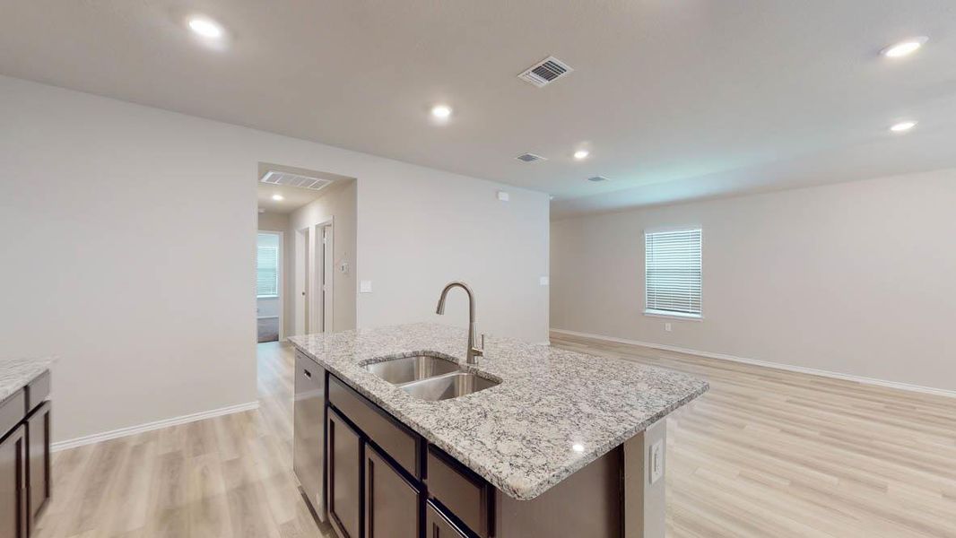 An inviting open-concept layout connects the kitchen with a generously sized living area. An inviting open-concept layout connects the kitchen with a generously sized living area.