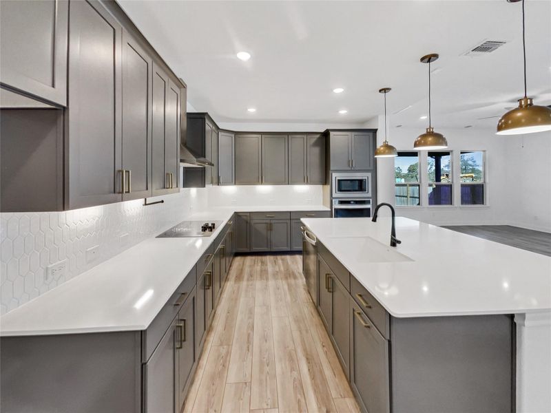 Kitchen featuring visible vents, a sink, light countertops, appliances with stainless steel finishes, and backsplash