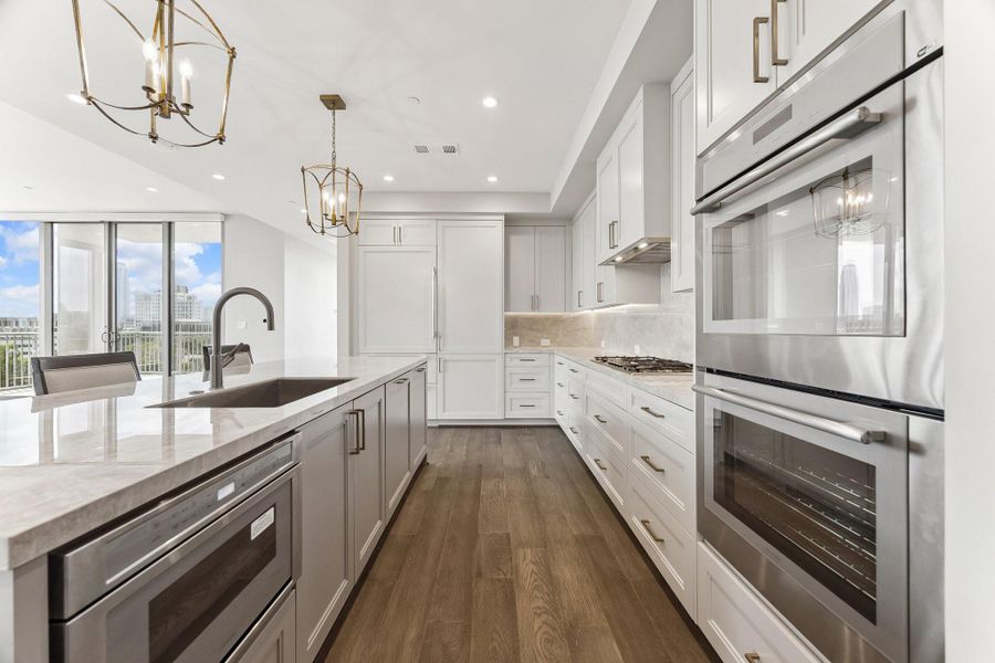 The ultimate kitchen, boasting an expansive layout with abundant soft-close cabinetry & drawers. This culinary haven is equipped with a premium Thermador appliance package, double ovens & sub-zero frig/freezer drawers.  Designed for both elegance and function. Offers unmatched space meal prep & hosting.