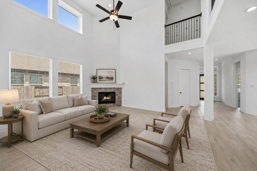 Gather the family and guests together in your huge living room! Featuring high ceilings, dark stained ceiling fan, gorgeous floors, and large windows that provide plenty of natural lighting throughout the day! *This photo has been virtually staged