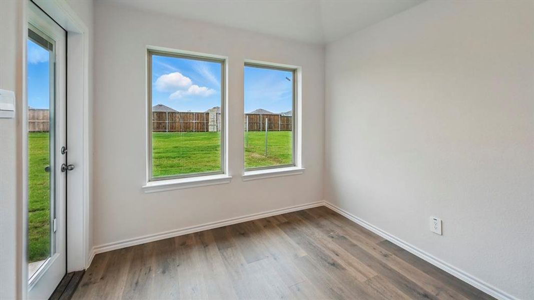 Unfurnished room featuring light wood-style flooring and baseboards Unfurnished room featuring light wood-style flooring and baseboards