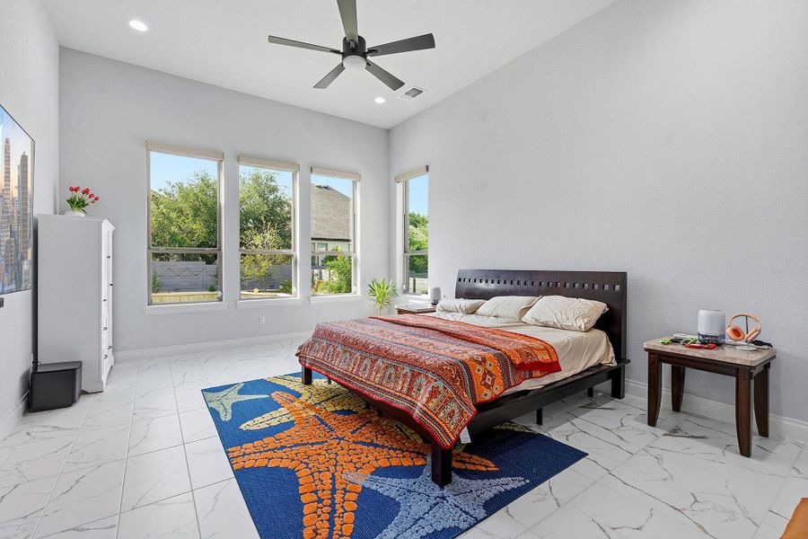 A well-lit primary bedroom features ample windows and tall ceilings, creating an airy and open retreat. A well-lit primary bedroom features ample windows and tall ceilings, creating an airy and open retreat.