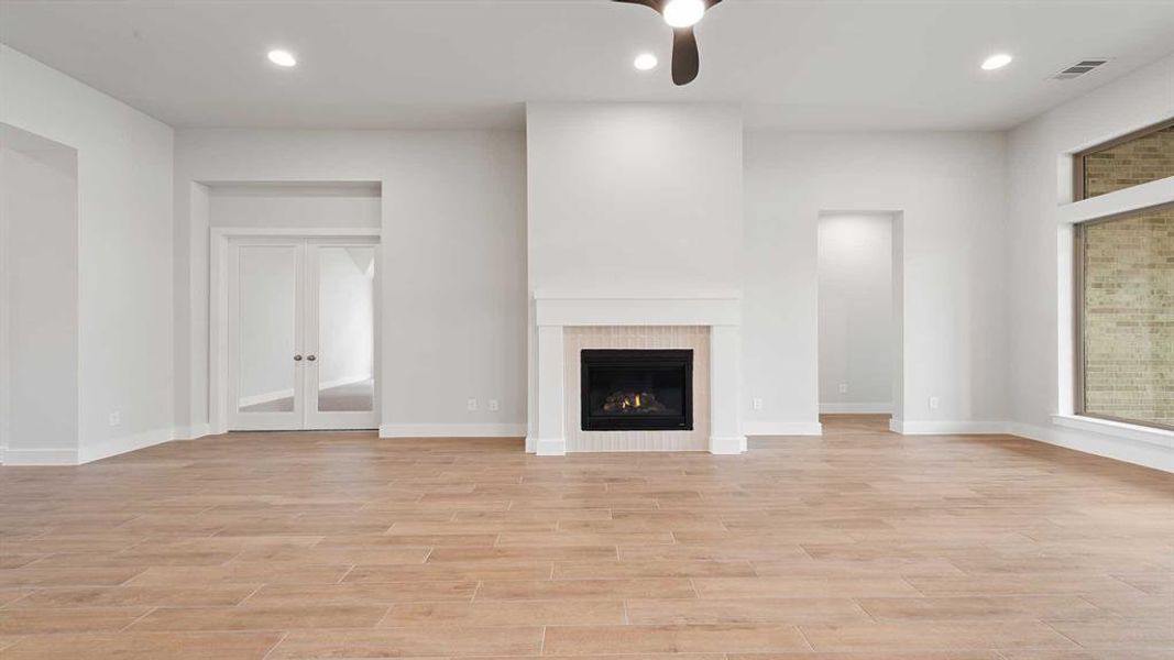 Unfurnished living room featuring light hardwood / wood-style floors and ceiling fan