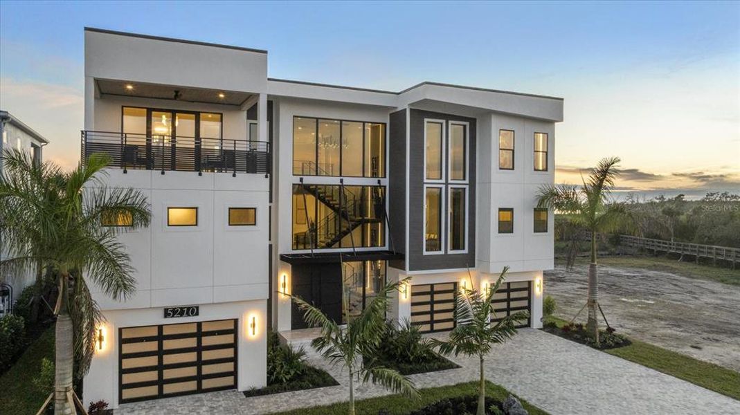 Front exterior of a new home in Legends Bay, Bradenton, FL, highlighting curb appeal (Image 24).