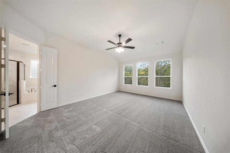 Unfurnished bedroom featuring a ceiling fan and carpet