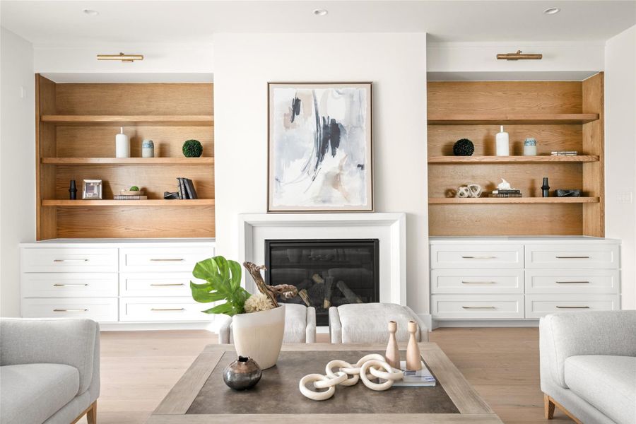 Elegant living room featuring a sleek gas fireplace framed by custom white built ins with natural wood accents, creating a perfect blend of warmth and modern sophistication. Elegant living room featuring a sleek gas fireplace framed by custom white built ins with natural wood accents, creating a perfect blend of warmth and modern sophistication.