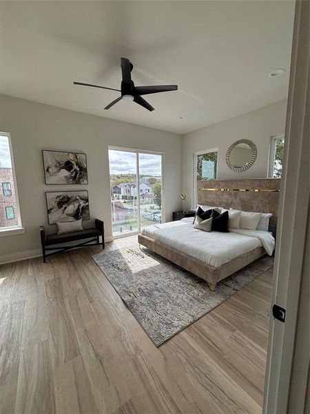 Bedroom featuring light wood-style flooring, ceiling fan, and access to exterior