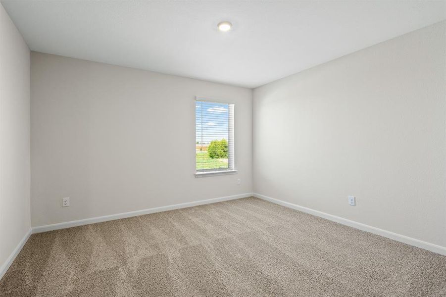 Carpeted empty room with baseboards