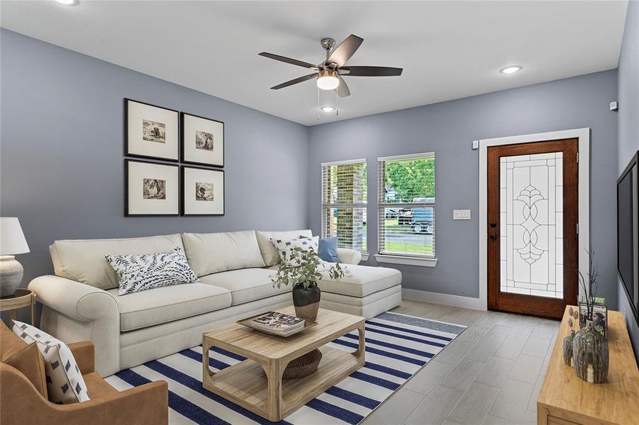 Living area featuring wood finished floors, recessed lighting, and a ceiling fan Living area featuring wood finished floors, recessed lighting, and a ceiling fan