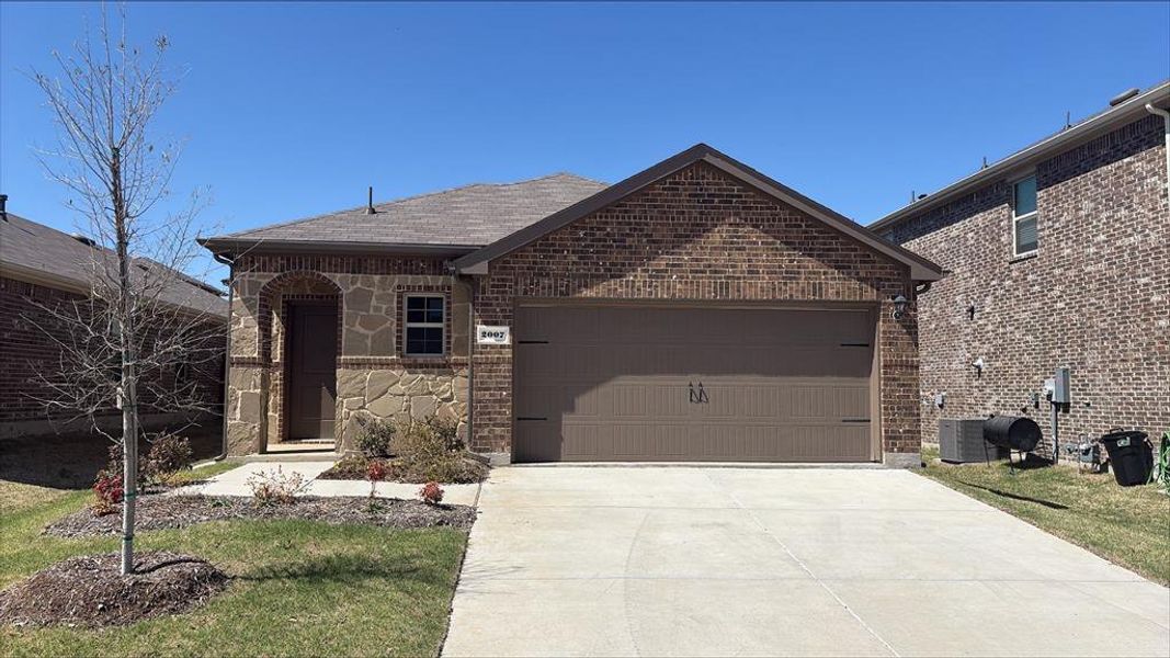 Front exterior of a new home in Wildcat Ranch, Crandall, TX, highlighting curb appeal (Image 2). Front exterior of a new home in Wildcat Ranch, Crandall, TX, highlighting curb appeal (Image 2).