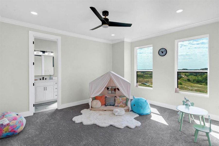 Game room with ornamental molding, sink, dark carpet, and ceiling fan