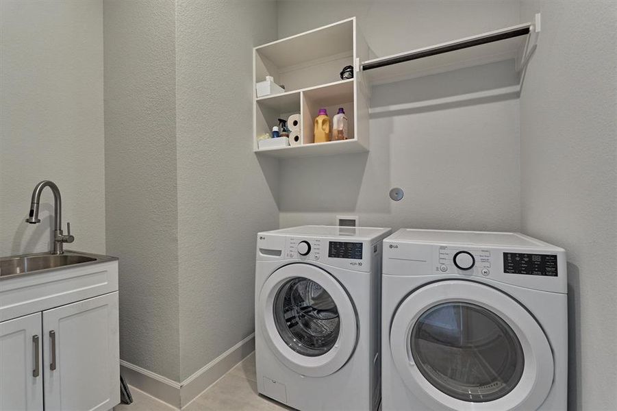 Utility room is a dream with bonus storage options/hanging space + sink.