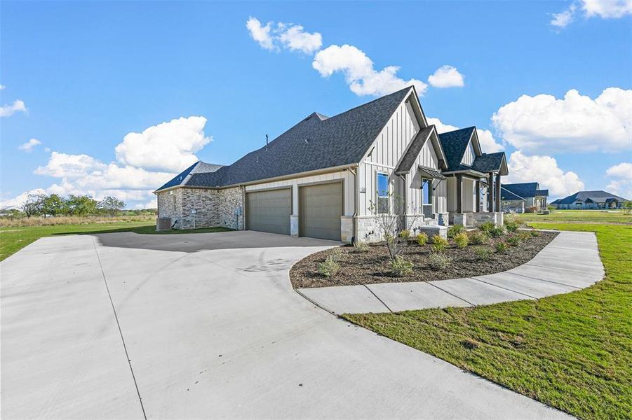 View of property exterior with a garage and a yard