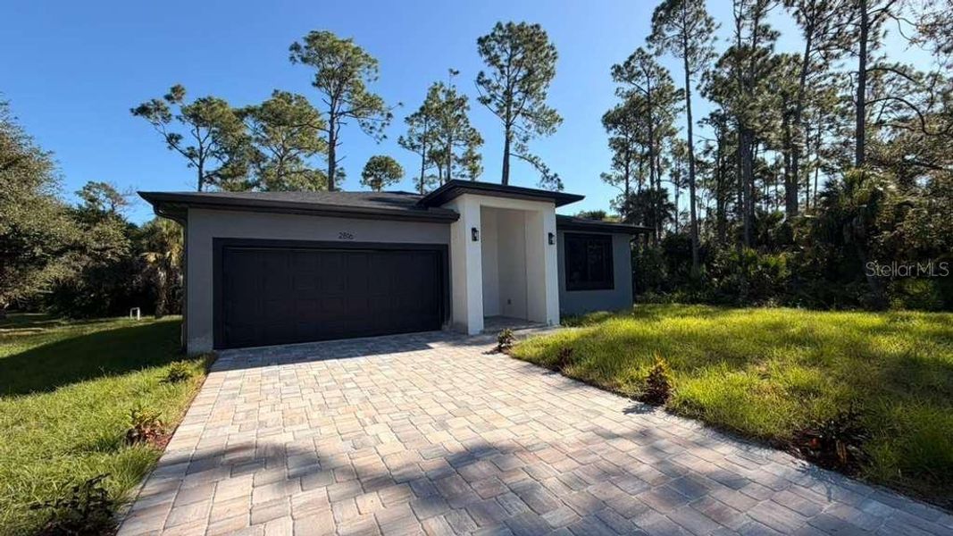 Front exterior of a new home in , North Port, FL, highlighting curb appeal (Image 25).